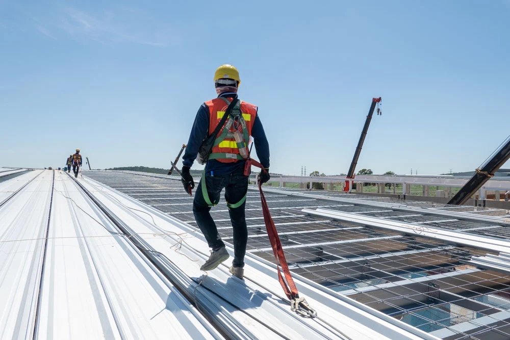 Construction worker wearing PPE woking at roof