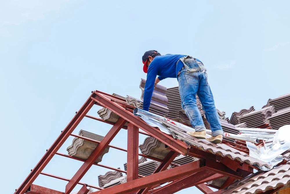 roof under construction with stacks of roof tiles for home building